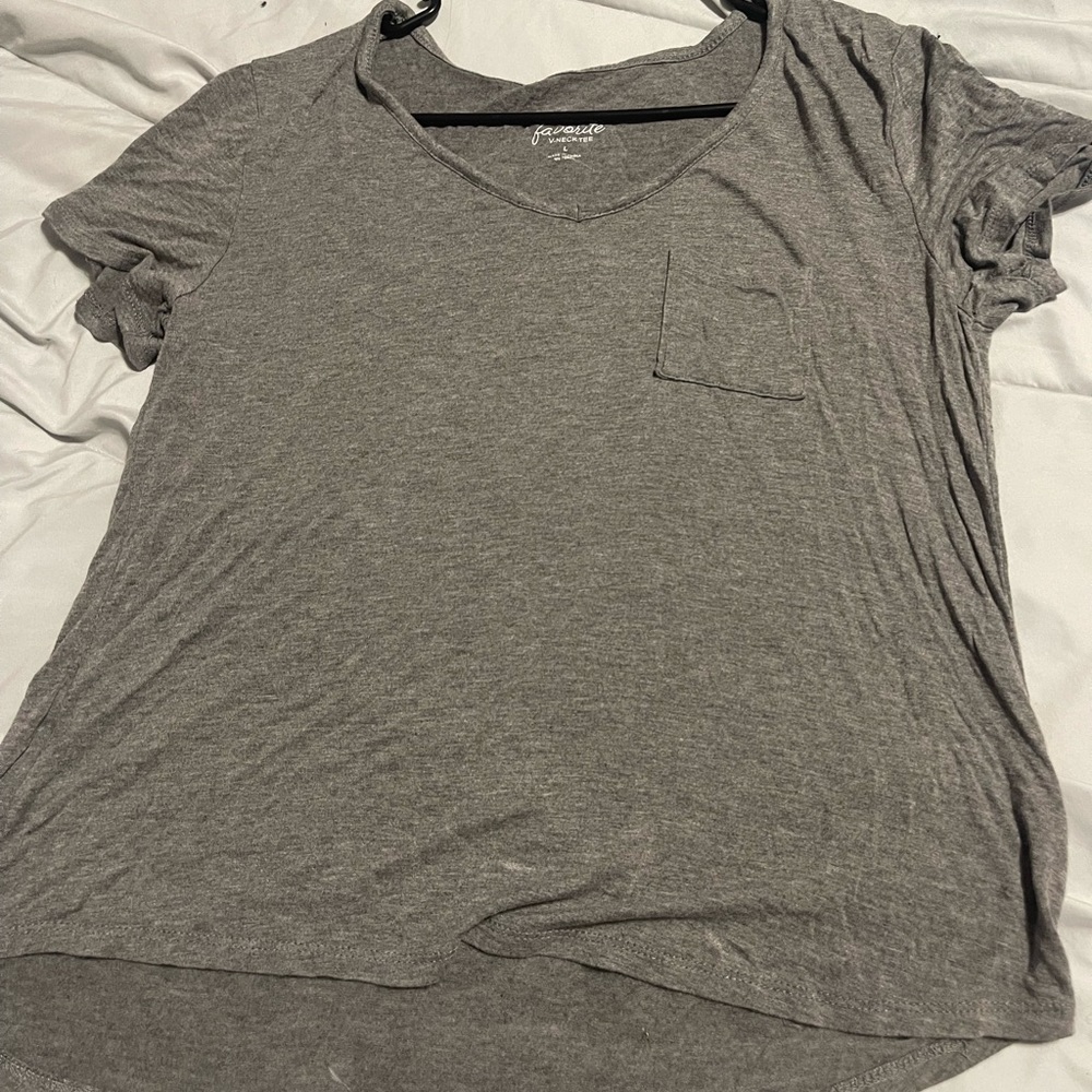Plain large grey shirt. Has small pocket. Loose fit.